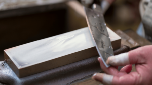 sharpening a knife on a whet stone