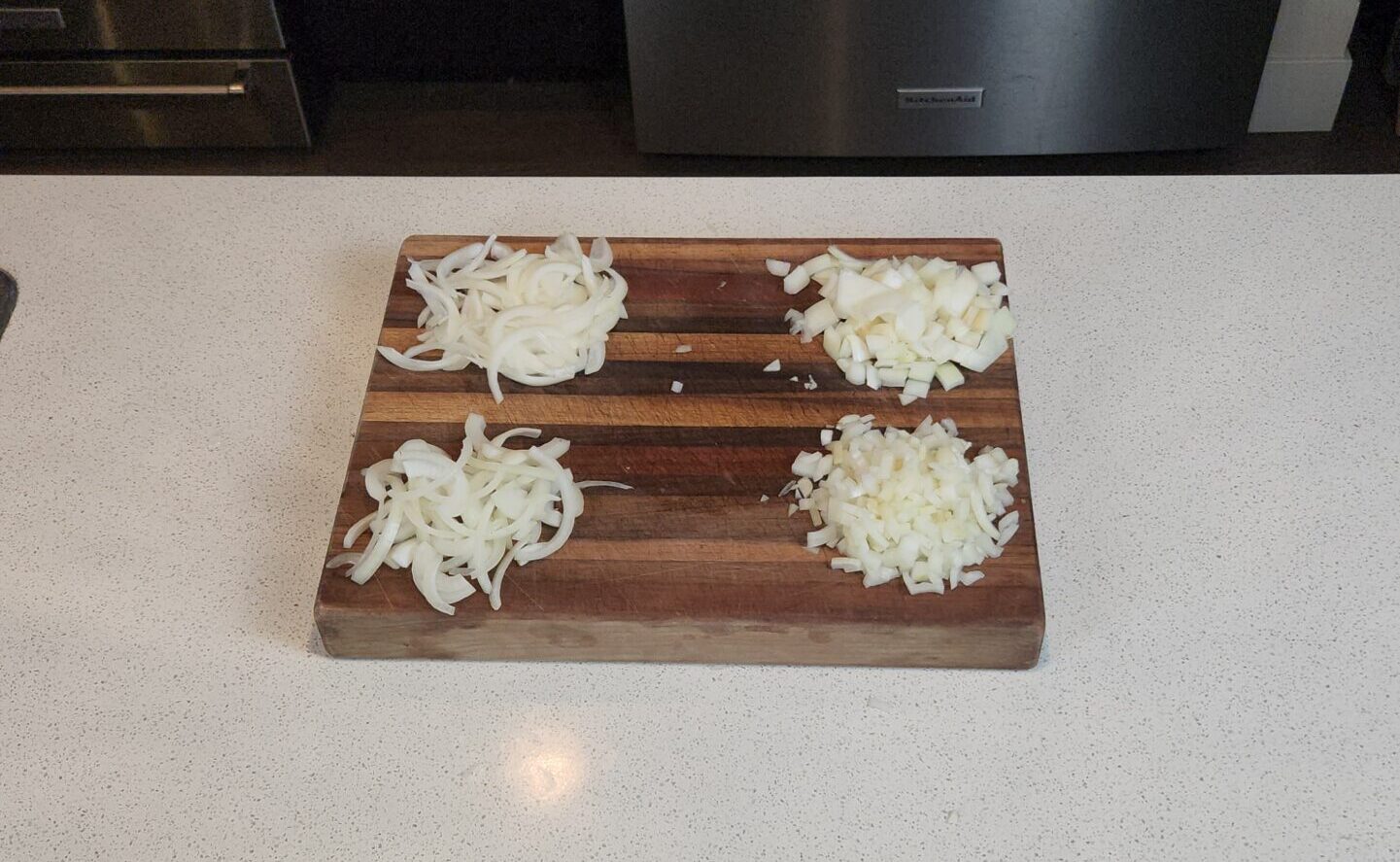 Four different onion cuts on a cutting board